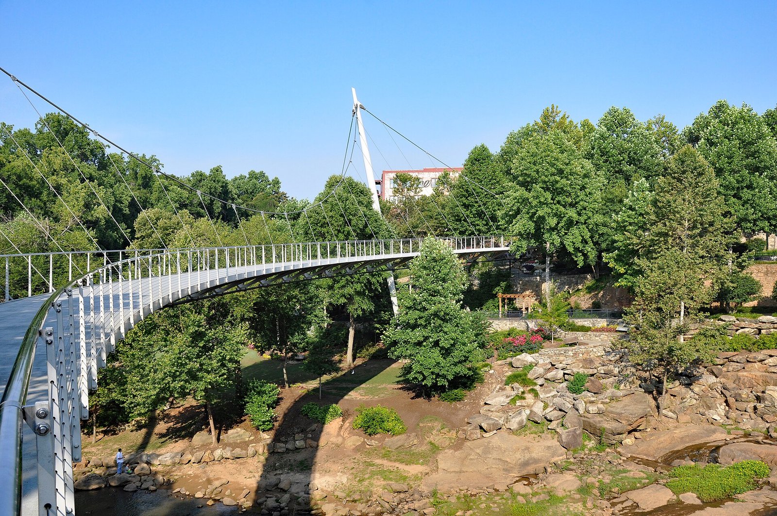 Liberty Bridge curving over Falls Park on the Reedy River in downtown Greenville, SC