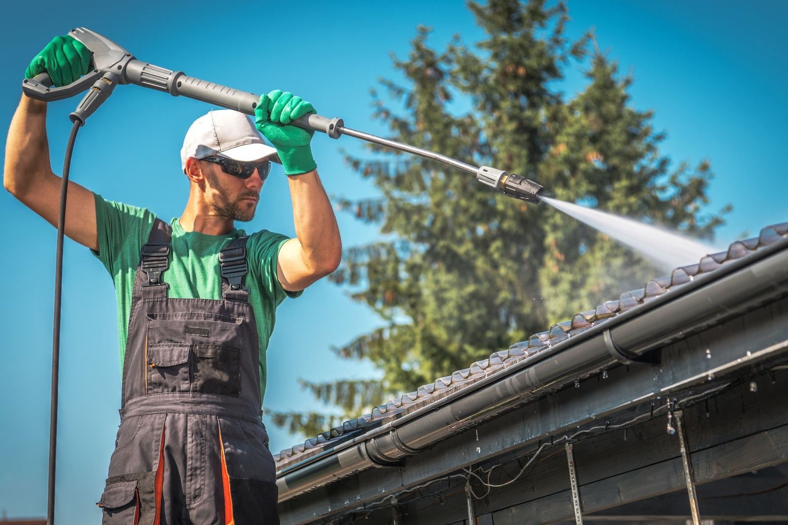 Gutter face being cleaned from a ladder