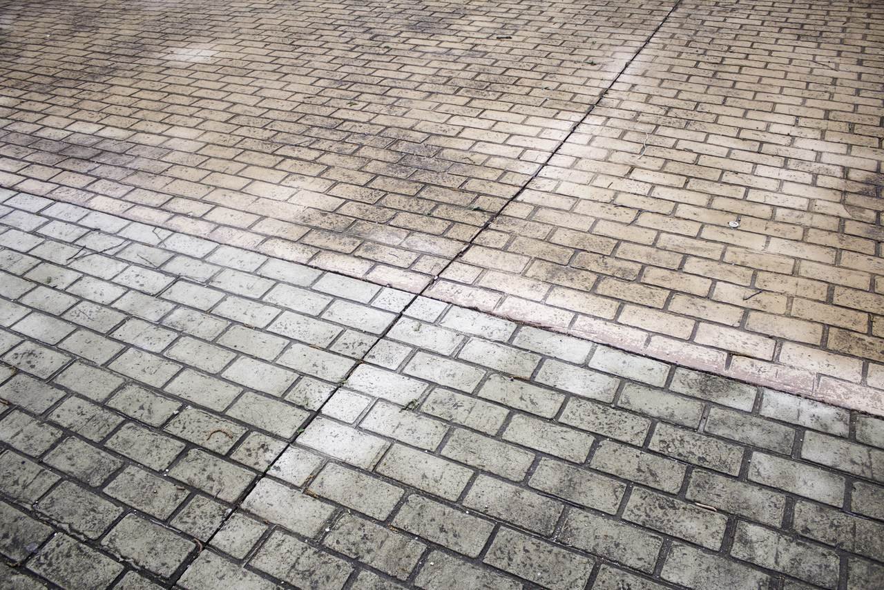 Paver surface part-cleaned showing the contrast